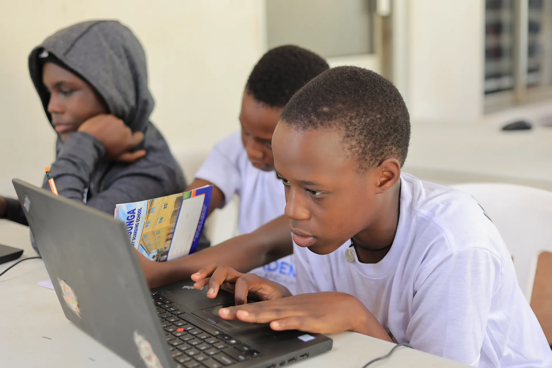Code Academy Uganda students building projects together